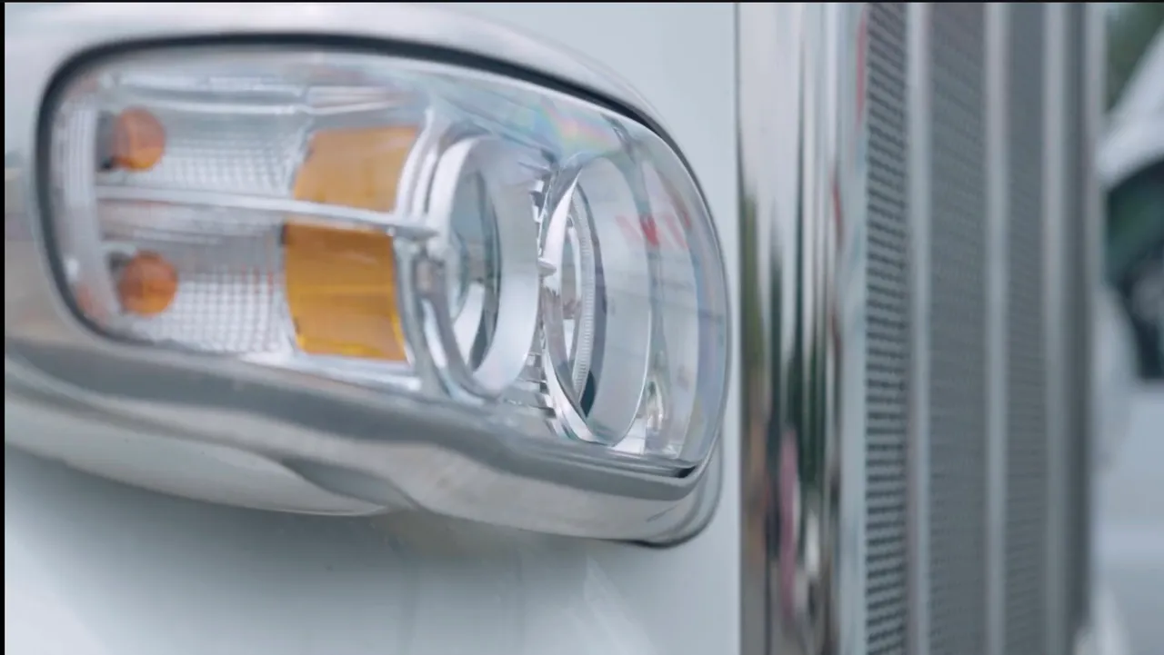 Close-up of a truck headlight and chrome grille